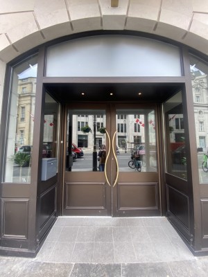 View of main entrance from pavement. Door straight ahead. Push door. Handles in tbe middle