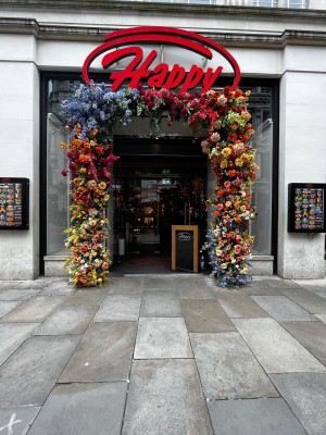 Photo of path to main entrance doors. Archway from street leads to doors.
