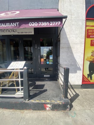 View from entrance from street. Step up to seating platform before door. Pull door via handle to the left.