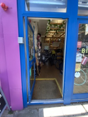Blue push door by seated height handle  on right side.