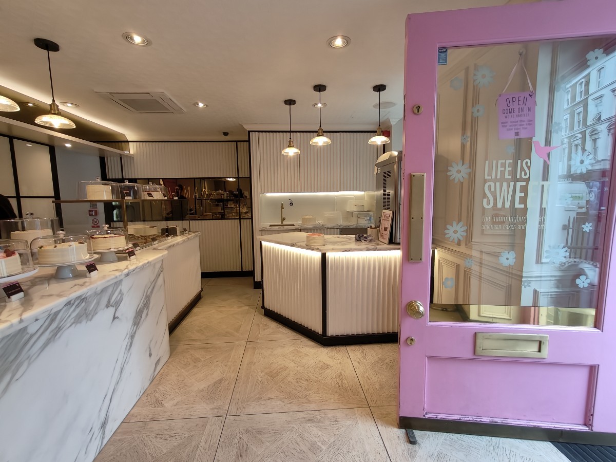 From entrance facing right. Display counter on left. Path ahead to coffee counter at back.