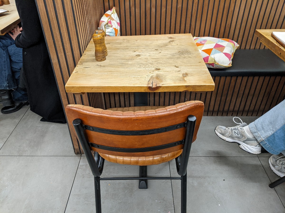 From tables with chairs facing left. Half booths with chairs ahead.