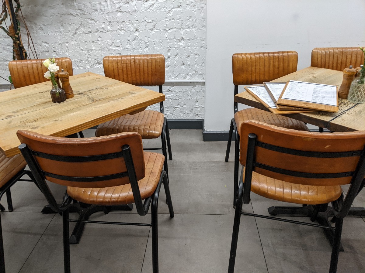 From end of counter facing right. Tables with chairs ahead.