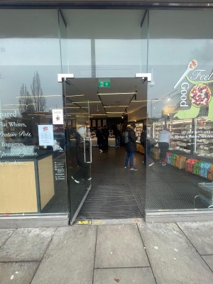 Glass door. Push silver handle on right to open.
