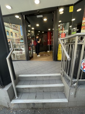 Three steps up to door at back. Silver handrails on both sides.