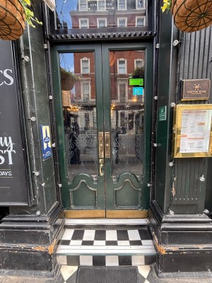 Glass doors with green frames. Push from centre to open.