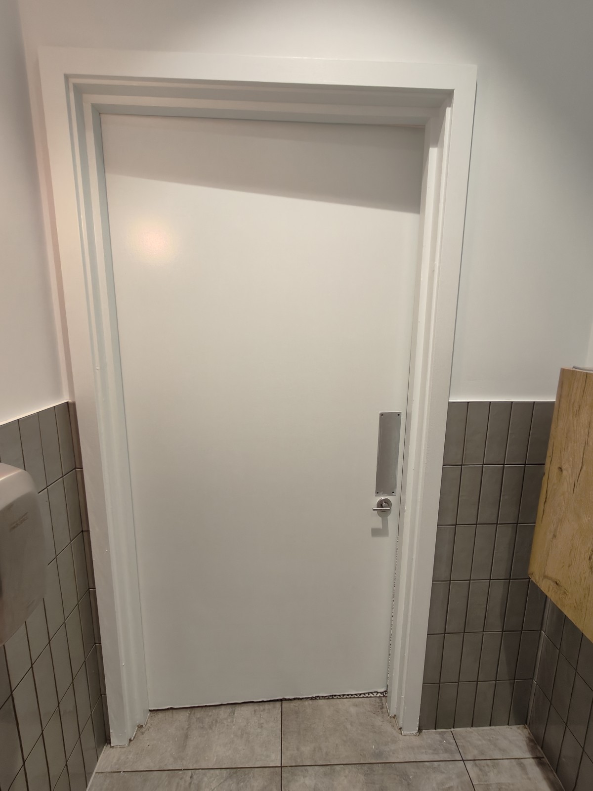 Back of door. Push from right to open.