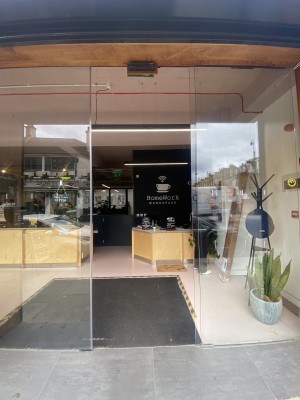 View of the entrance looking straight ahead from pavement. Sliding door to the right.