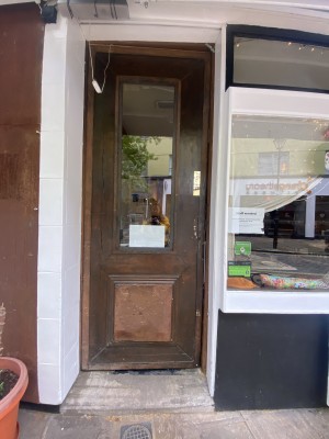 View of the entrance door looking straight ahead from pavement. Push to open.
