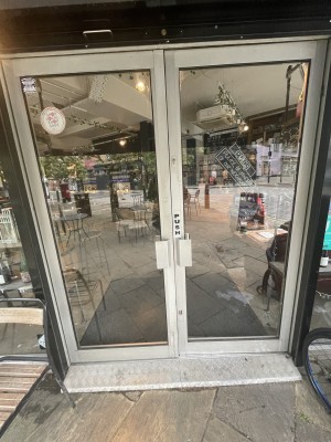 White framed glass doors. Push from centre to open.