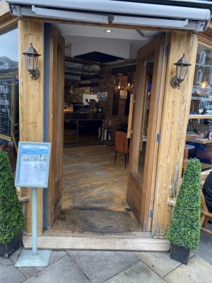 Main entrance are double glass wooden push doors with door handle on left side of right door.