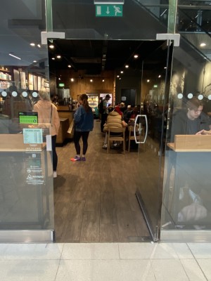 Single glass door. Silver metal handle on left. Push to open.