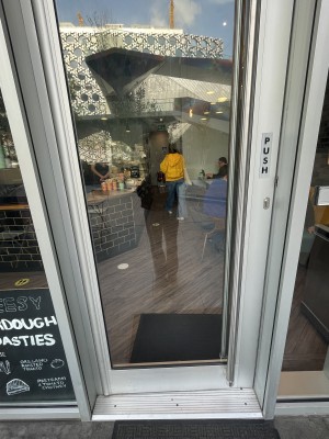 View of entrance door. Push door from the right using handle along right side.