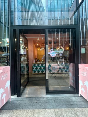 Double glass doors with black frame. Silver pads in middle. Push to open.