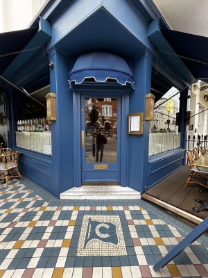 Blue framed glass door ahead. Push from left to open.