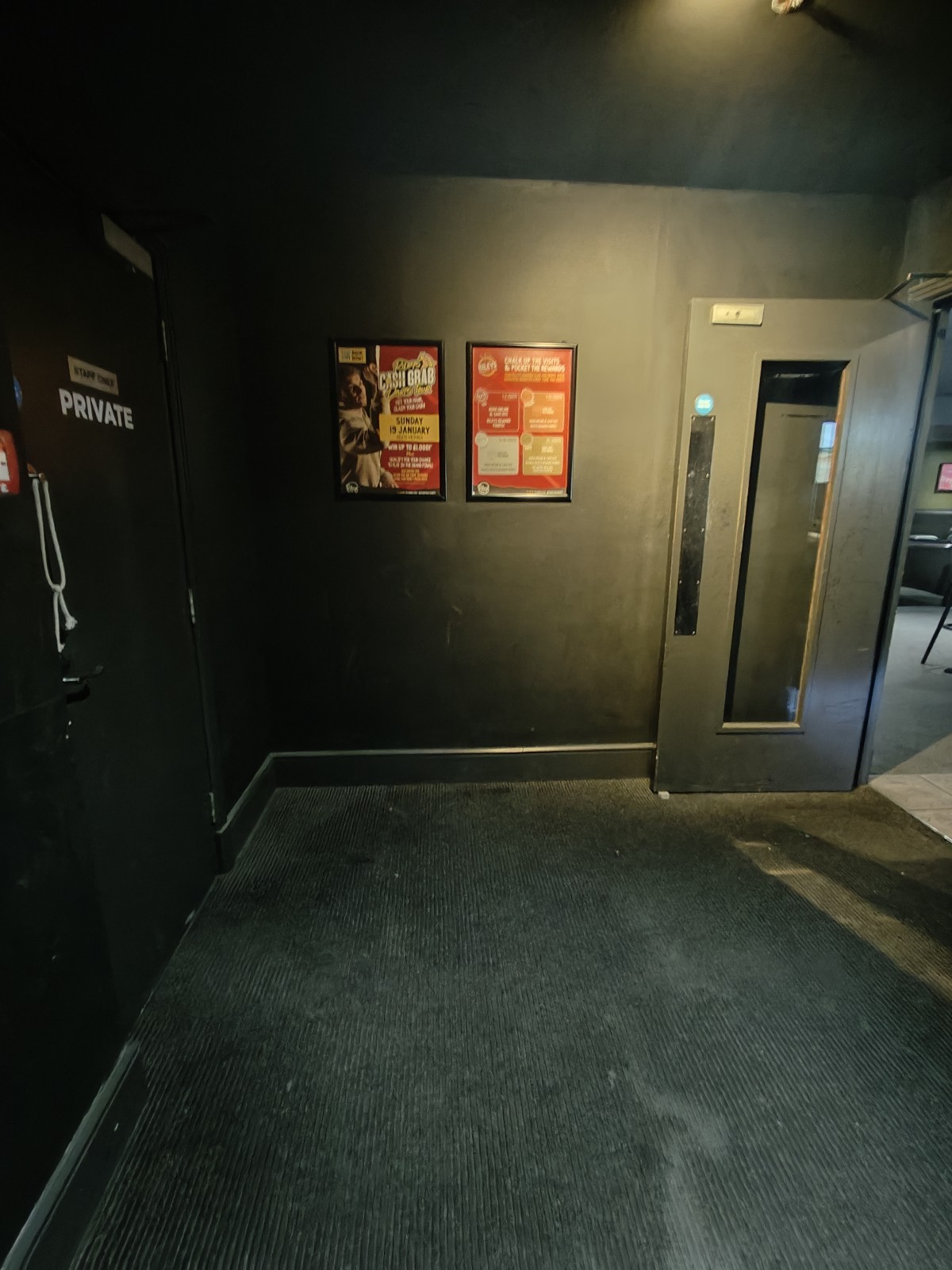 From bottom of stairs facing left. Path ahead to door on right.