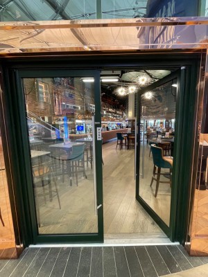 Double push doors. Push from middle of the doors using handles along it. There is a small bump at door.