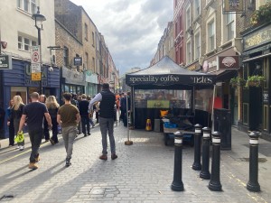 Venue is a street stand with access via cobbled path to its left.