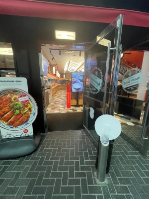 Stand with push button to front right of door. Door straight ahead.