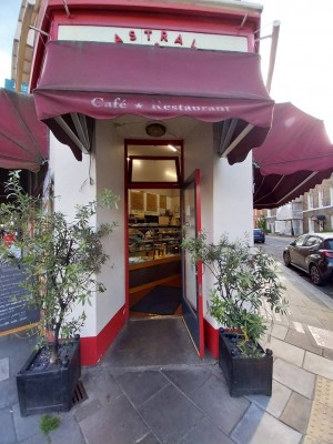 Glass door with red frame. Silver, metal handle on left. Pull to open.