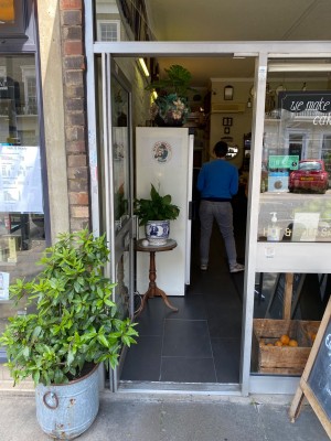Single glass push door with handle on right side of door at seating height. One small bump along front.