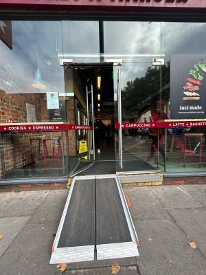 Double glass doors with horizontal red strip across centre. Vertical silver metal handles in centre, push to open.
