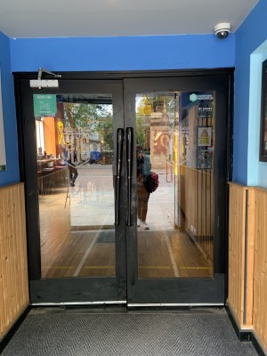 (2) View of second set of doors following first. Doors pull to open via vertical handles where doors meet.