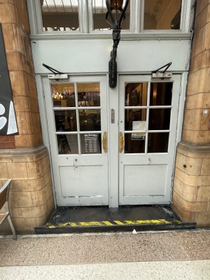 Single step leading up to door at main entrance. Two doors available but they are separated by a centre piece. The left door pulls open from the right.
