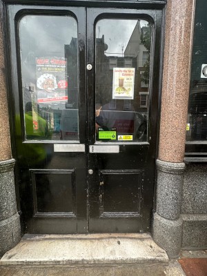 Main entrance. 1 step and after it double glass and wood door. Push.