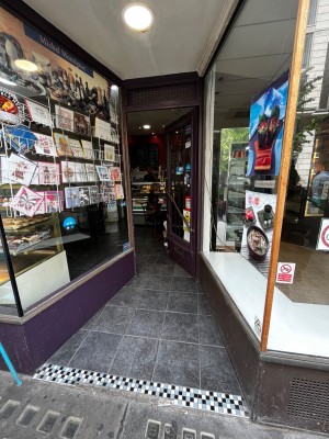 Very small step leading up to main entrance. Single door.