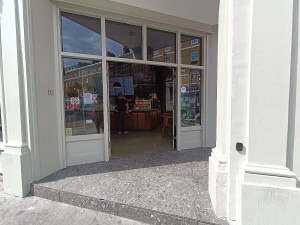 Step up to doors. Bell on right pillar. Doors at back.