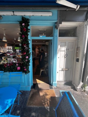 Push lock on left side of blue door to open.