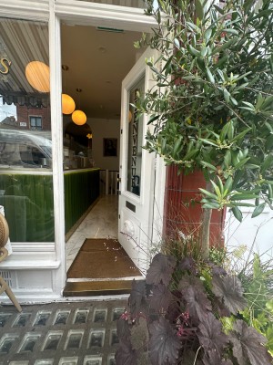 Main entrance. 1 step and after it wood and glass door. Pull.