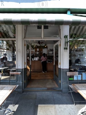 Double glass doors with white and grey frames. Push metal gold handle in the middle to open. Carpeted area after doorway.