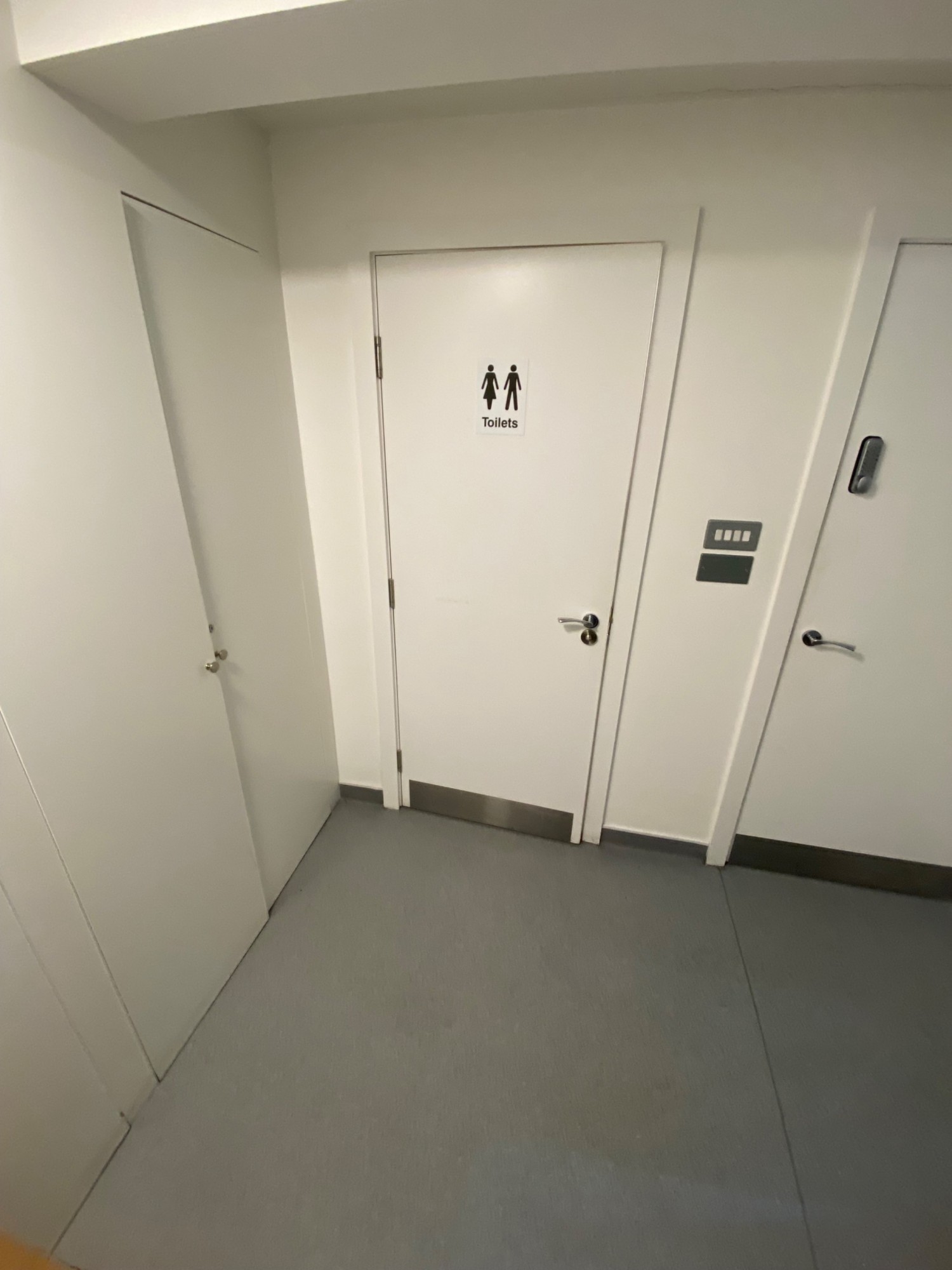 Standing at bottom of staircase looking right. Pathway to bathroom straight ahead.