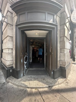Brown doors with handle in the middle. Push to open.