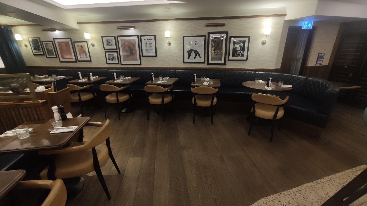 From end of counter facing straight. Path ahead to left. Half booths along back wall.
