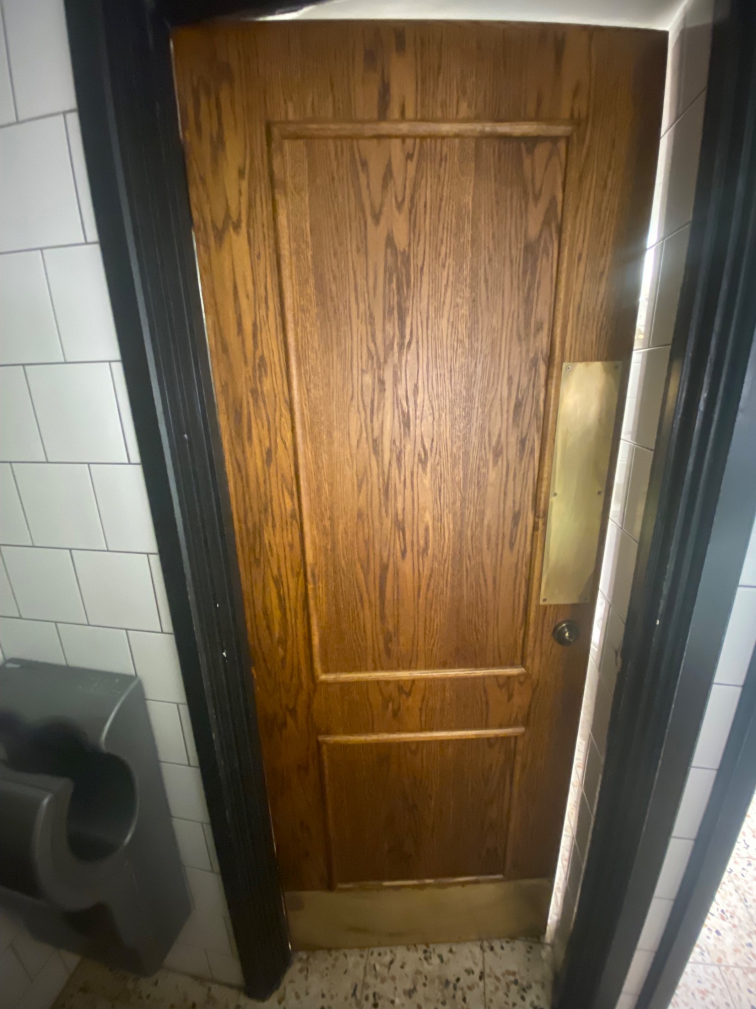 From end of sink facing left. Cubicle door ahead. Push to right to open.