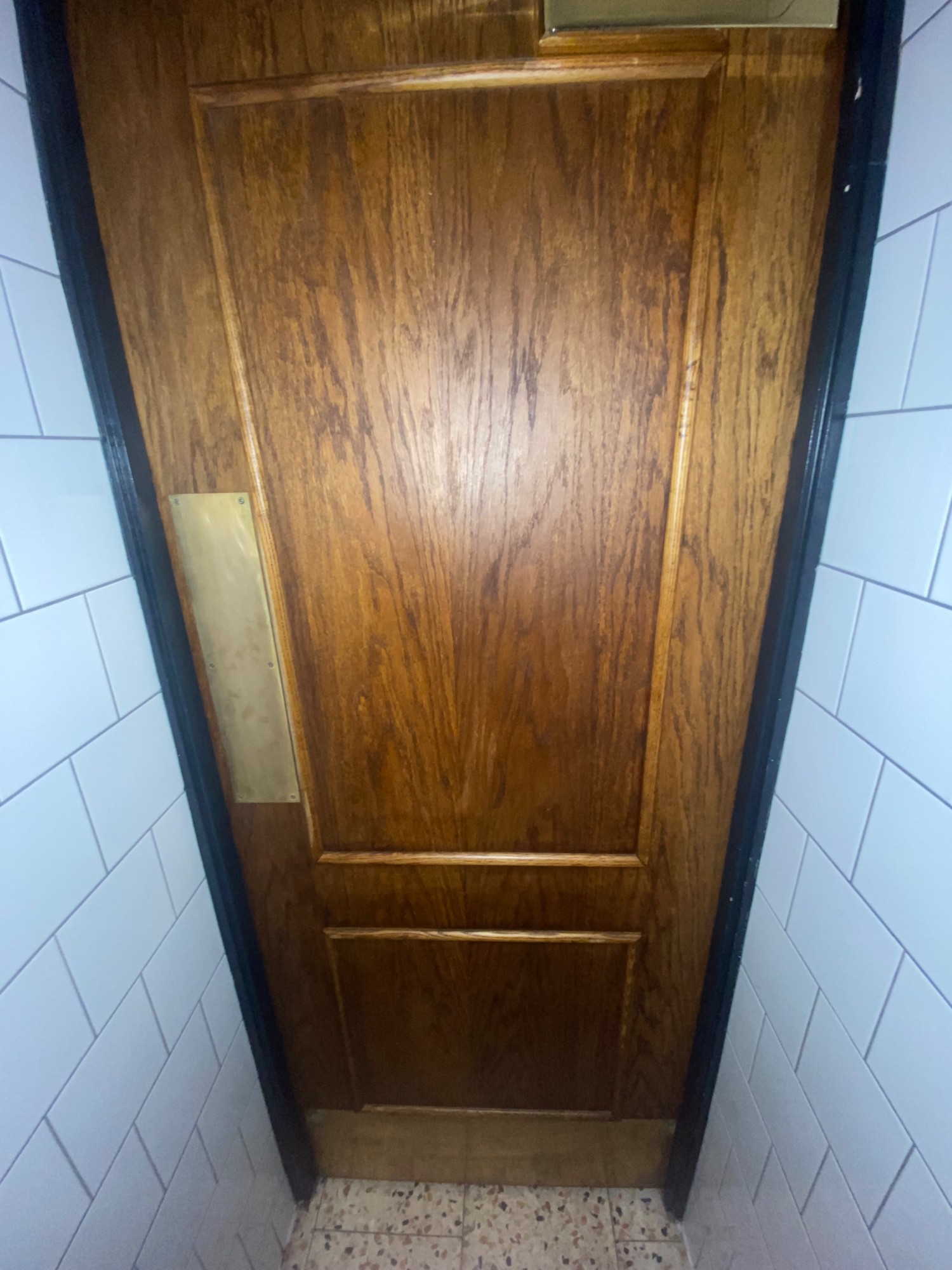From door facing straight. Brown door ahead. Push to left to open.