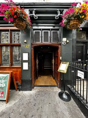 Wooden double door. Golden handles on the middle. Push to open.