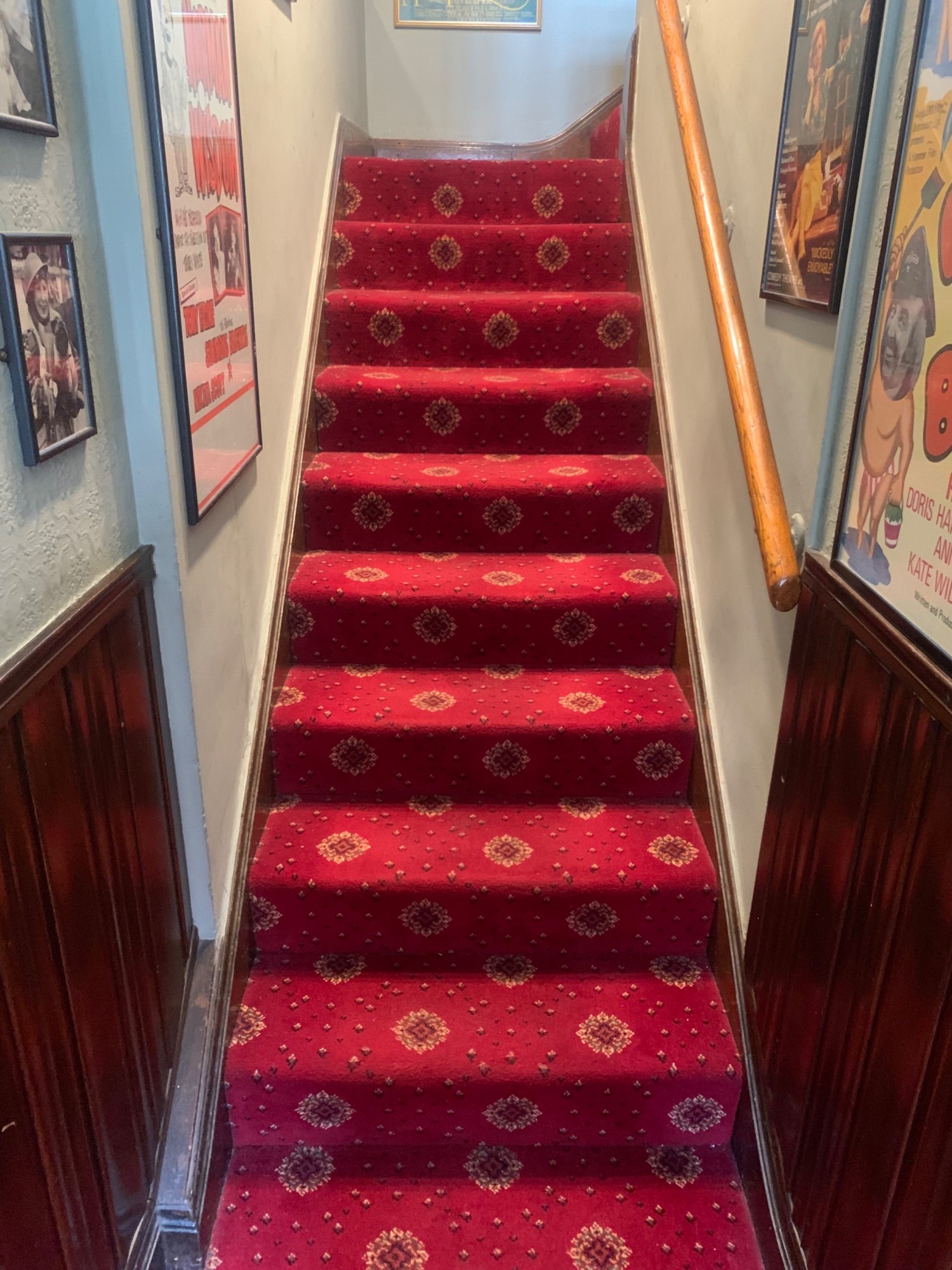 From door facing right. First flight of stairs ahead. Brown handrail on right.