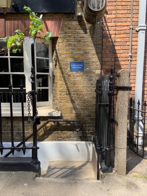 Gate to stairs to main entrance on right side of venue. One step down to landing, turn left to main staircase.