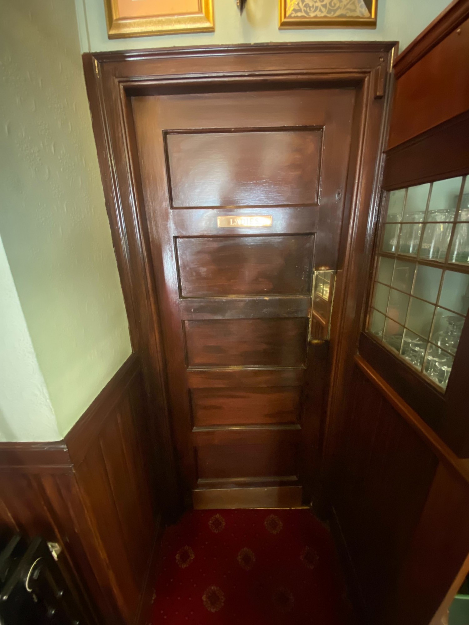 From end of path facing straight. Wooden door ahead. Push from the right to open.