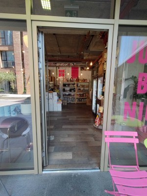 Glass door ahead. Push silver handle on right to open.