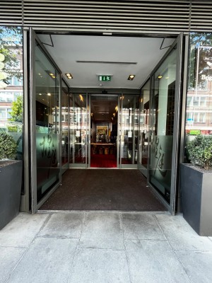 Main entrance. Very large double doors leading to second set of sliding doors to enter venue. Push double doors to open.