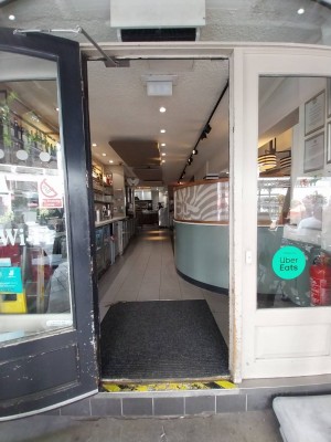 Entrance to venue from outdoor area. Manual door pull open from right.