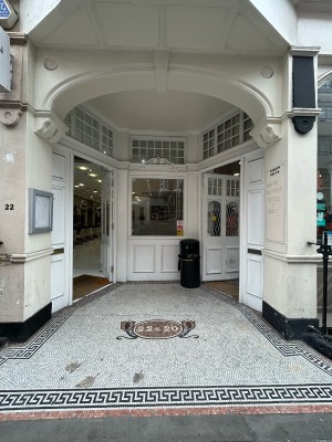 From street, facing venue. White wide arch precedes main venue door on right.
