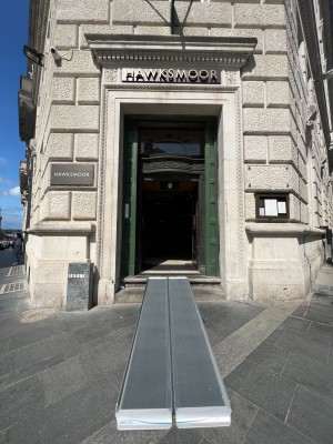 Main entrance are two sets of double doors. First set of doors are dark green push doors with two steps along front. Ramp in middle.