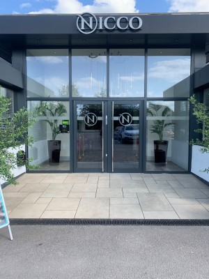 Doors set back to the right from the carpark. Pull from centre to open with vertical handles.