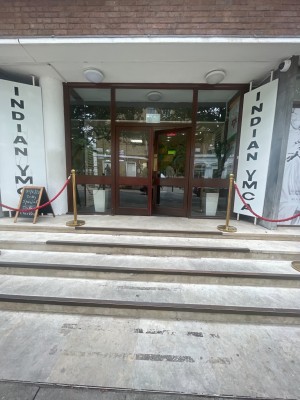 From the street looking straight at main entrance.  Four wide steps to enter. Double glass doors in the centre.